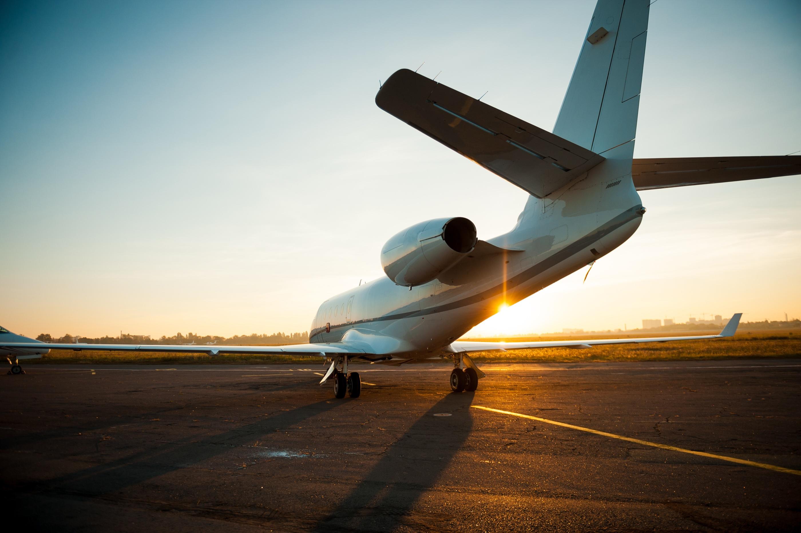 Private aircraft on a runway at sunset