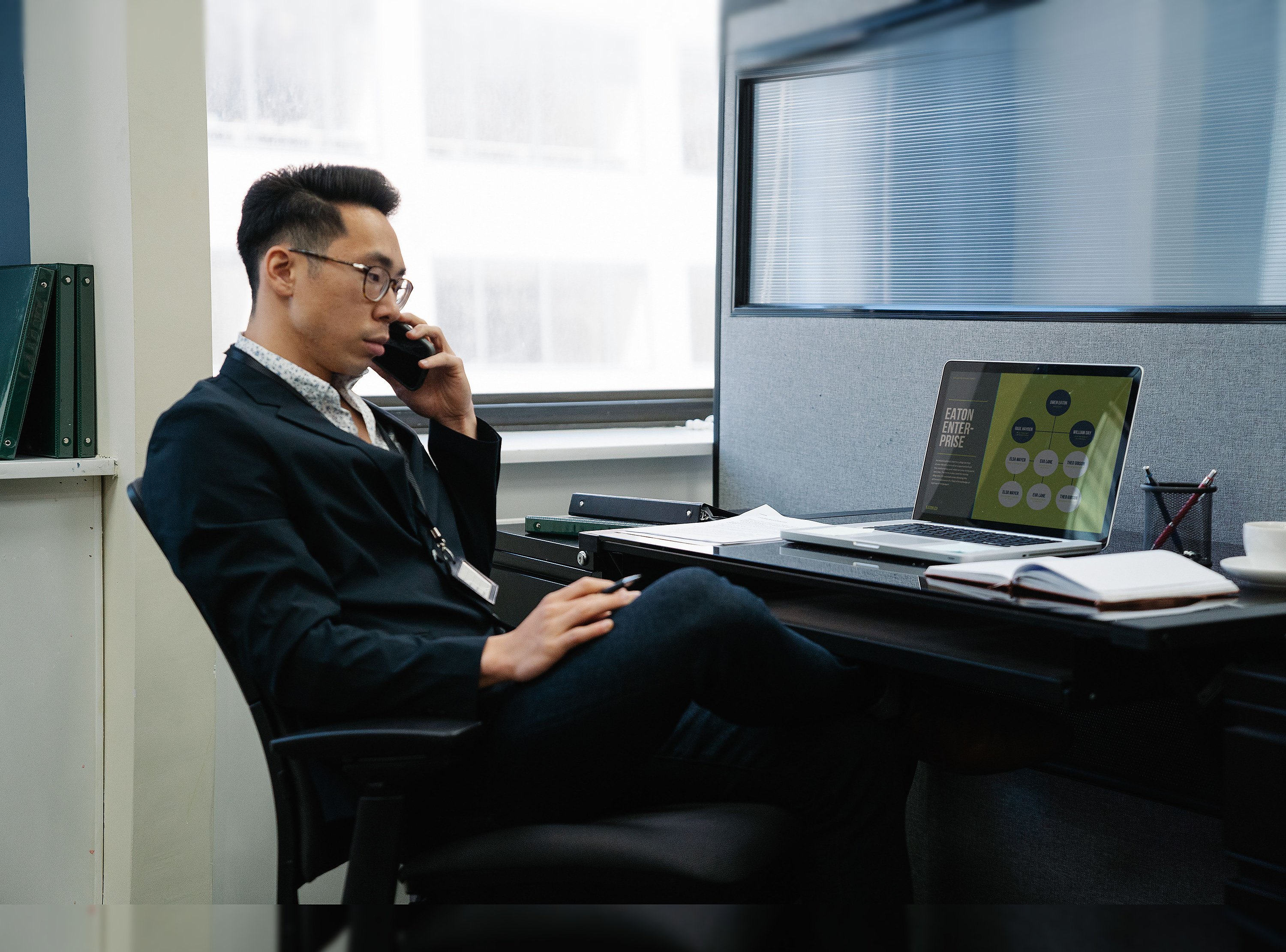 A man at his desk on the phone representing family office coordination