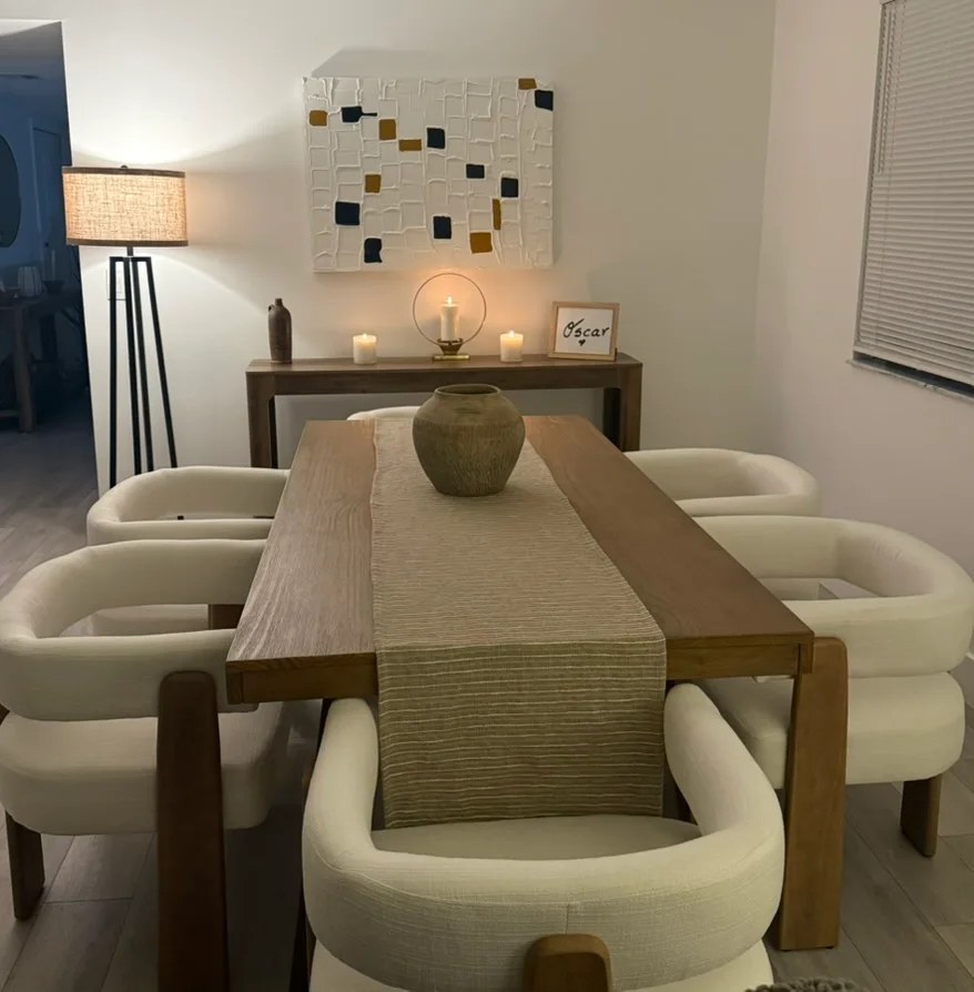 Completed dining room with warm wood furniture and upholstered chairs