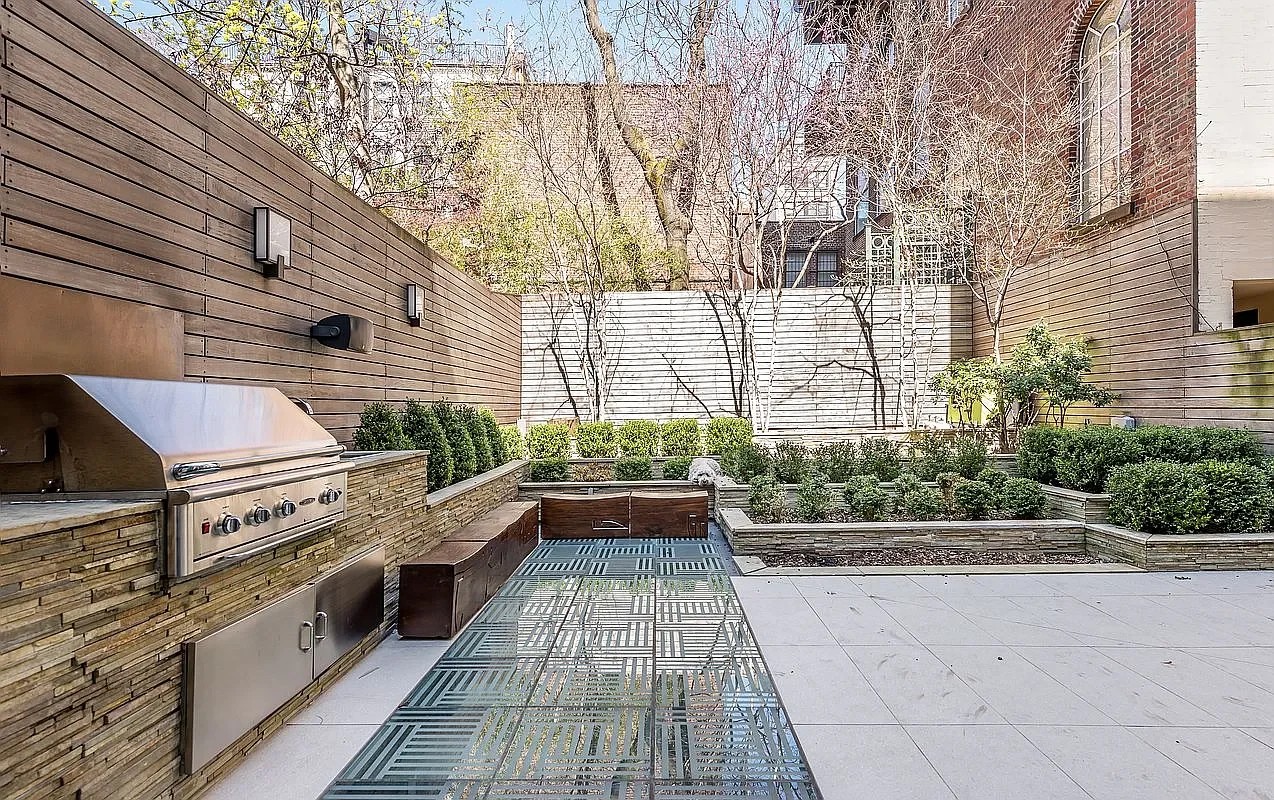 Walkable glass skylights integrated into the courtyard above the pool
