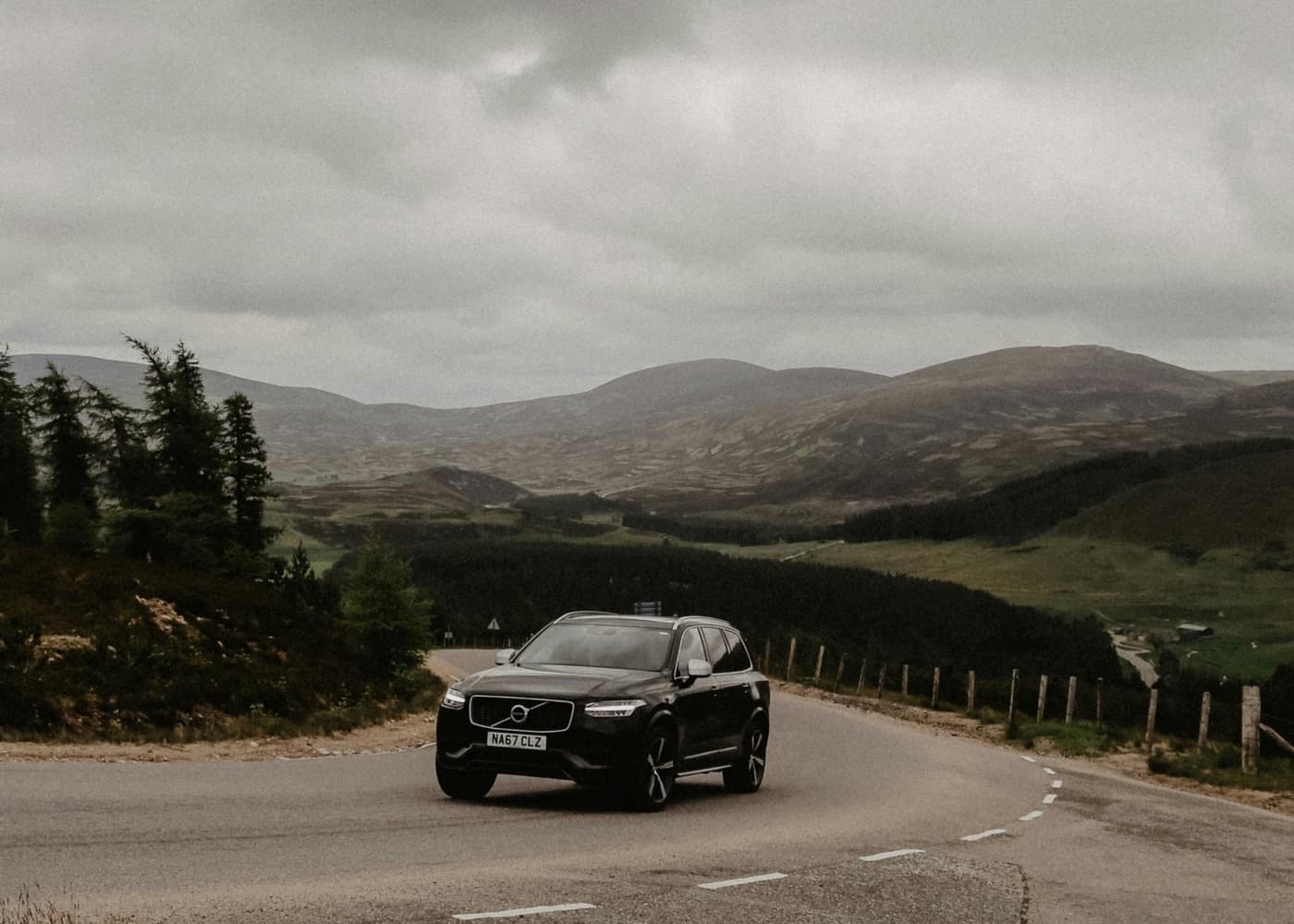 SUV on a mountain road representing ground transportation and logistics
